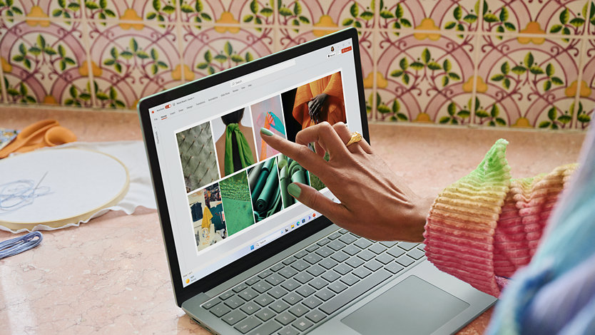 A student creates a colorful mood board in PowerPoint for a fashion design class.