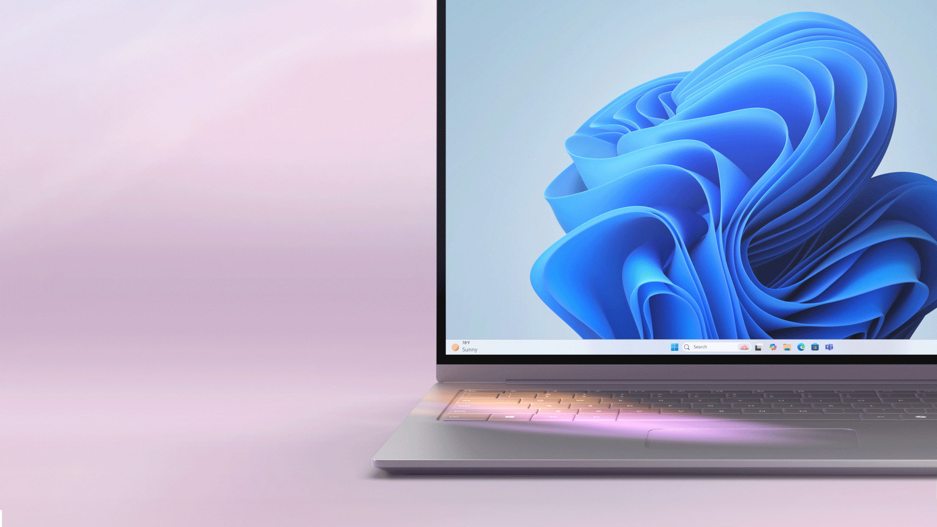 An open laptop with the blue Windows bloom screen on a light purple background