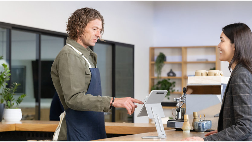 Person ordering at a café counter