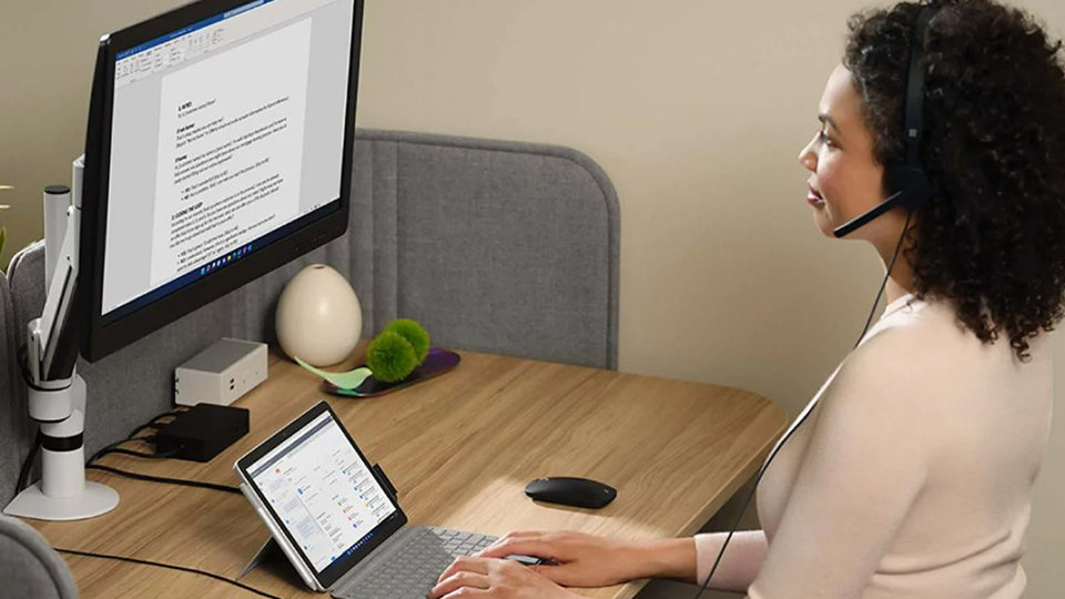 A person connects Surface Go 4 to Surface Dock 2 to add a 4k monitor and have a full desktop PC experience